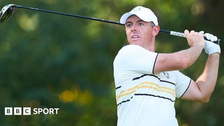 Bradley ‘didn’t’ help rein in ‘horrific’ Ryder Cup abuse – McIlroy Rory McIlroy watches his ball after hitting a shot with a wood. He is wearing a European Ryder Cup outfit - a baseball cap and a predominantly white polo shirt with black and yellow narrow hoops and trim.