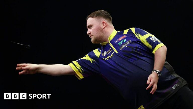 Luke Littler defeats Gary Anderson to reach UK Open quarter-finals Stock picture of Luke Littler throwing a dart. The photograph is taken side-on.