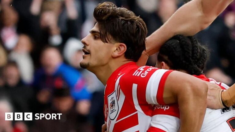 Super League: St Helens 34-24 Wigan Warriors – Leyland’s debut double earns derby win St Helens celebrate Bill Leyland's try against Wigan Warriors