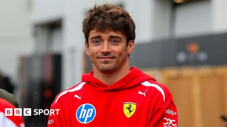 Charles Leclerc poses in the paddock ahead of the Canadian Grand Prix