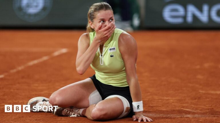 Maja Chwalinska sits on the ground and covers her face with her hand after reaching the French Open final
