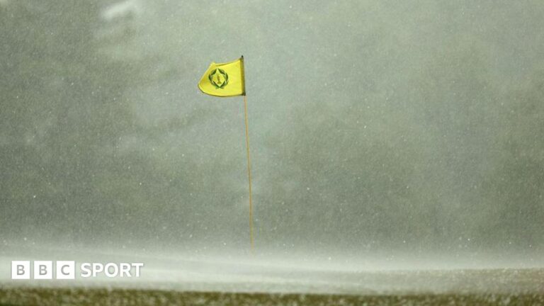 Memorial Tournament third round suspended because of thunderstorms A flag billowing in the wind in heavy rain