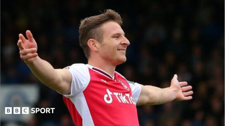Paul Mullin: Fan favourite striker leaves Wrexham by mutual consent Paul Mullin with outretched arms celebrates a goal for Wrexham in 2021