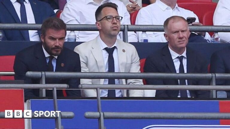 Salford City: Wembley defeat, manager sacked – what’s going on? Salford co-owner David Beckham (left) and football director Paul Scholes sit either side of chief executive Gavin Fleig at Wembley