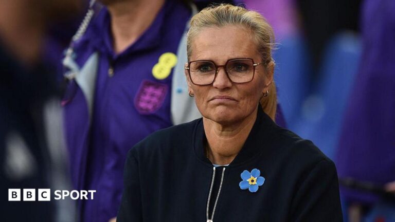 Why England missed out on automatic Women’s World Cup spot A frowning Sarina Wiegman in dark top and yellow and blue broach