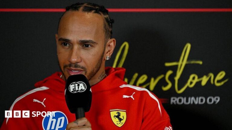 British Grand Prix: Lewis Hamilton says Silverstone will be ‘completely different’ with 2026 cars Lewis Hamilton holds a microphone while answering questions in the news conference at Silverstone