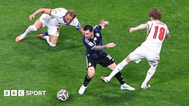 Lionel Messi: How Argentina great picked apart England with masterclass World Cup performance Lionel Messi of Argentina in action with Harry Kane and Anthony Gordon of England during Argentina's World Cup semi-final win against England. Kane is on the ground and Gordon's left leg looks to be swinging towards Messi as the England players, in white, try to dispossess Argentina's captain, in dark blue.