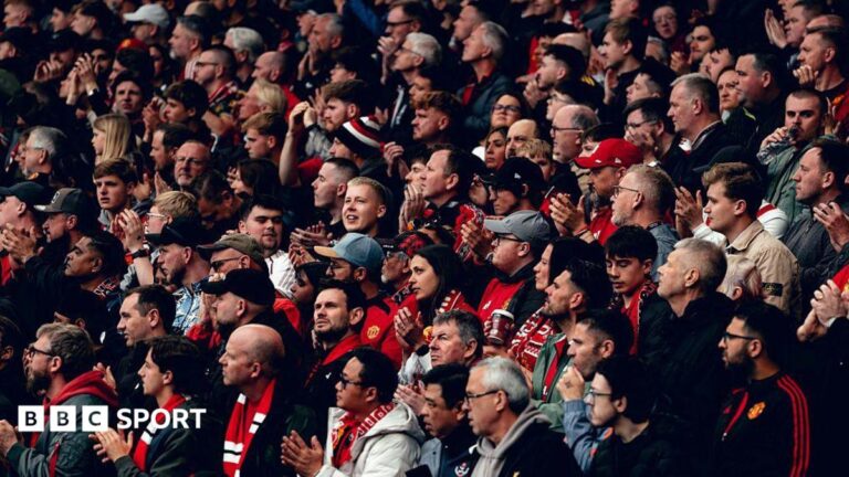 Manchester United fans applaud before kick off of a Premier League fixture against Liverpool