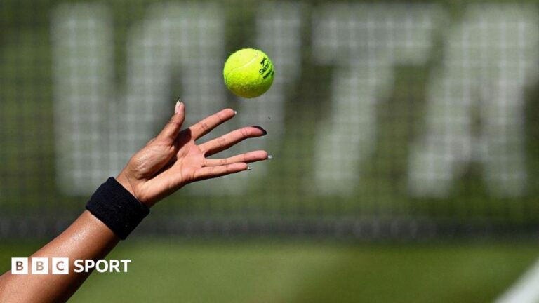 WTA to require tennis players to undergo genetic sex testing A female tennis player with long fingernails (only the hand shown) tosses a tennis ball in front of a net featuring WTA