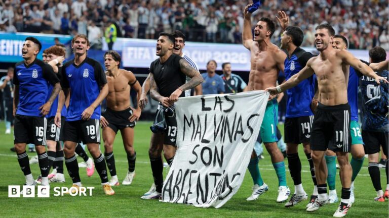 The Argentina players celebrate at full time with a banner that reads "The Falkland Islands are Argentinian" during the FIFA World Cup 2026 Semi Final match between England and Argentina