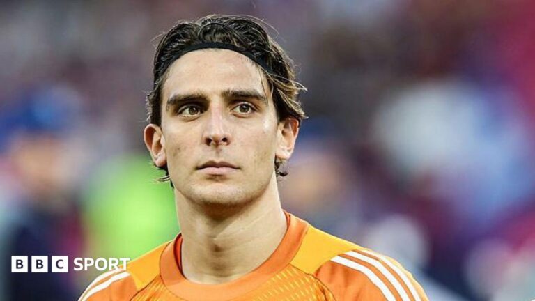 Hull City sign goalkeeper Konstantinos Tzolakis for club-record fee Head and shoulders of Konstantinos Tzolakis, wearing an orange goalkeeper shirt