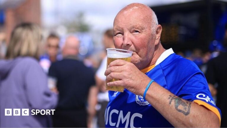 An Everton fan drinks a beer before the Premier League match against Crystal Palace
