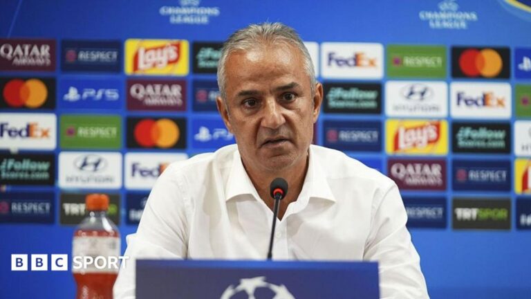 Fenerbahce boss announces shock resignation after Roma draw in Champions League Ismail Kartal, pictured in a white shirt sitting behind a microphone and in front of a blue board covered in colourful sponsor logos