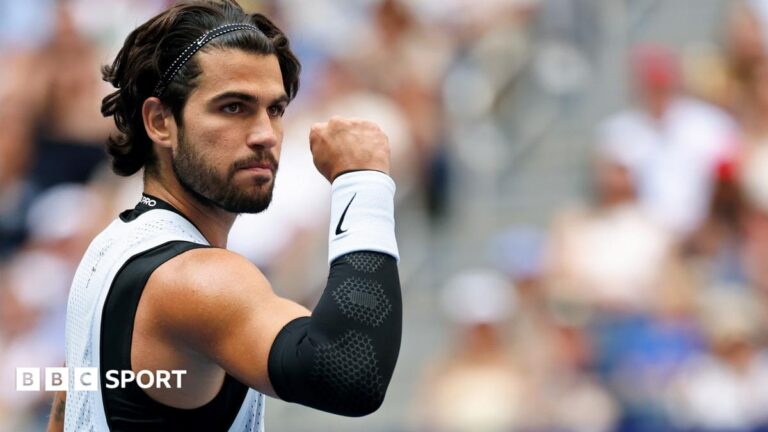US Open 2026 results: Carlos Alcaraz beats Tommy Paul to reach quarter-finals Carlos Alcaraz, wearing a white vest, clenches his fist